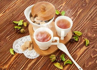 tea with sugar cubes on wooden