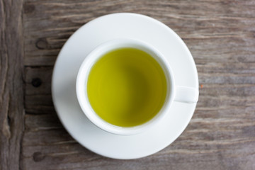Hot green tea on wood table.