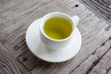 Hot green tea on wood table.