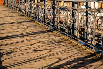a wooden bridge in the city on a sunny day