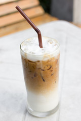 Iced coffee with milk is on the table.