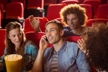 Fototapeta premium Annoying man on the phone during movie