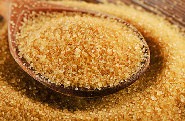 Raw Organic Cane Sugar in  wooden spoon