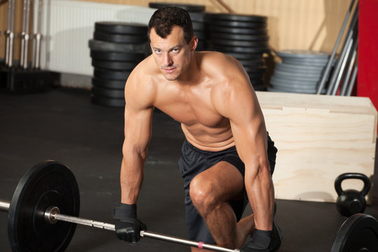 crossfit training man with barbell