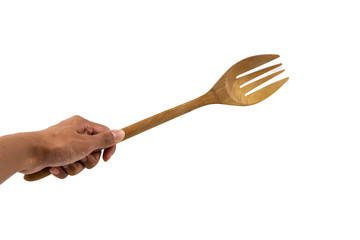 Wooden kitchen fork  on human hand isolated on white background