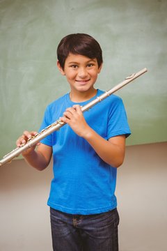 Boy Playing Flute In Classroom