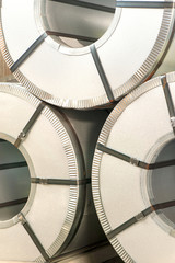Many bended metal sheet rolls in factory warehouse. Metal indust