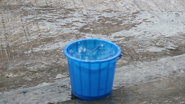 bucket slave rain water flowing down
