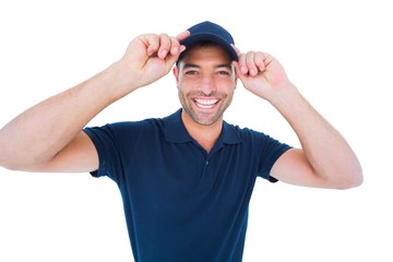 Smiling delivery man wearing cap on white background