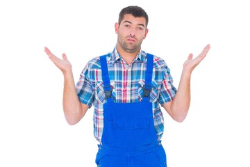Naklejka premium Confused handyman giving I dont know gesture
