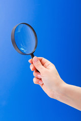 Magnifier glass in woman's hand