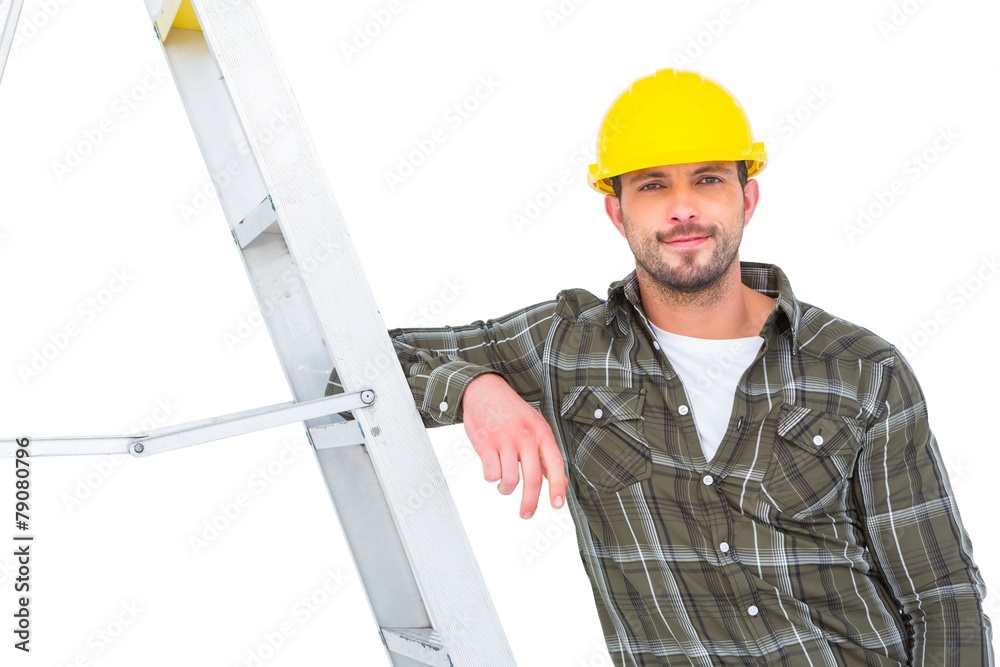 Poster smiling handyman in overalls leaning on ladder
