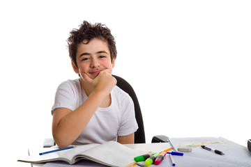 Fototapeta na wymiar Boy holds his chin smiling in front of homework