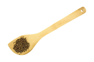 Cardamom seeds on a wood spoon