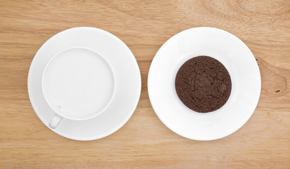 Chocolate cookie on plate with milk