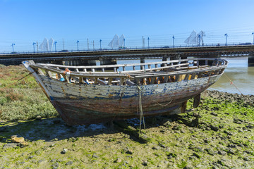 Fototapeta na wymiar Old fishing boats on the shore of a river