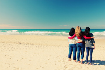 Three best friends walking at seaside