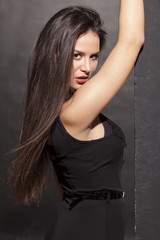 pretty young woman leaning against the wall