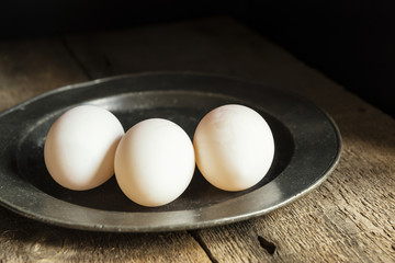 Fresh duck eggs in moody vintage retro style natural lighting se