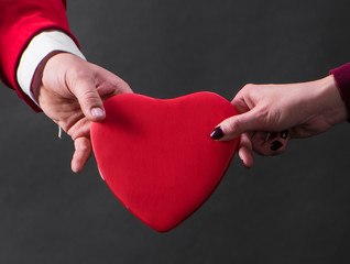 Close up of woman and man hands with heart