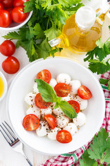 traditional salad with mozzarella and cherry tomatoes, vertical