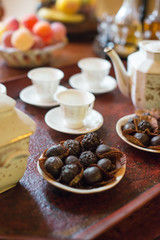 Tea, cups and sweets on the table.