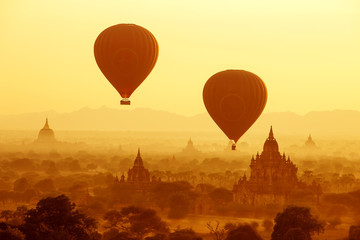 air balloons over Buddhist temples at sunrise. Bagan, Myanmar.