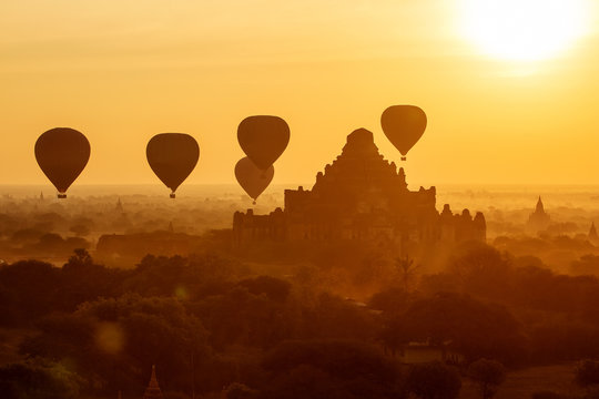 air balloons over Buddhist temples at sunrise. Bagan, Myanmar.