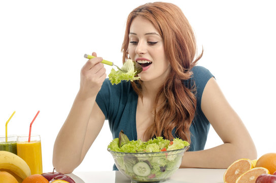 Woman having a table full of organic food,salad,juices,smoothie