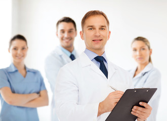 smiling male doctor with clipboard