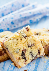 Fruit cake with streusel over light blue background