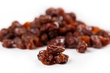 Heap of sultana raisins on white background
