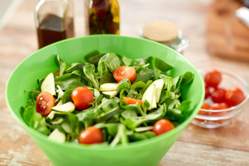 close up of salad bowl and spices on kitchen table
