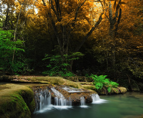 Fototapeta na wymiar Waterfall with blue stream in the nature Thailand forest