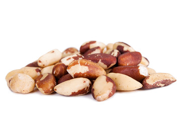 Five big, beautiful, Brazilian walnut on a white background.