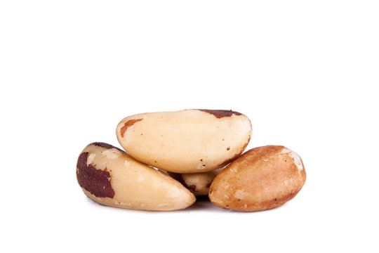 Five big, beautiful, Brazilian walnut on a white background.