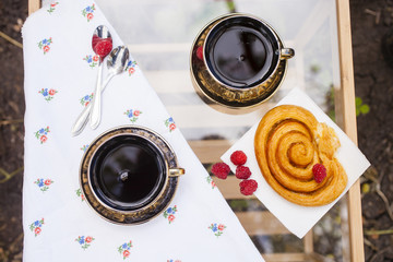 cups of tea and roll with raspberry