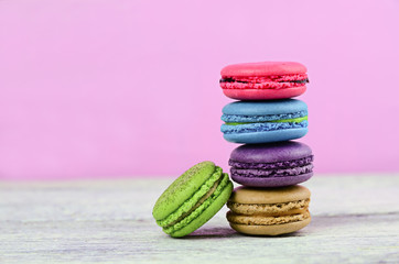 colourful stack flavoured macaron on white wood background