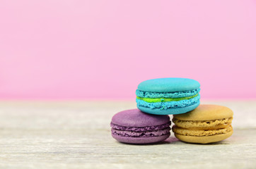colourful stack flavoured macaron on white wood background