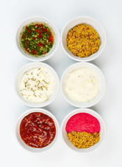 Variety of sauces in white bowls
