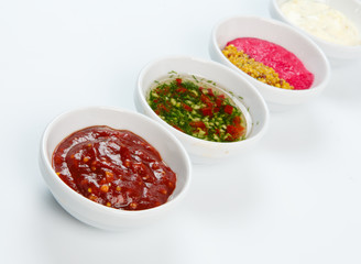 Variety of sauces in white bowls