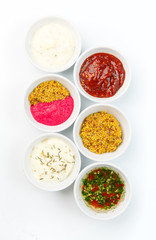 Variety of sauces in white bowls