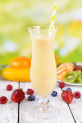Delicious berry cocktail on table on bright background