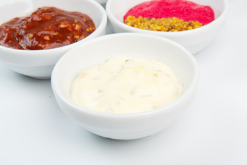 Closeup of sauces in white bowls