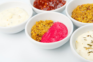 Closeup of sauces in white bowls