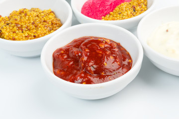 Closeup of sauces in white bowls