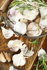 Raw garlic and spices on wooden table