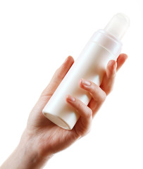 Female hand with cosmetics bottle isolated on white