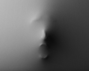 Screaming human face pressing through fabric as horror