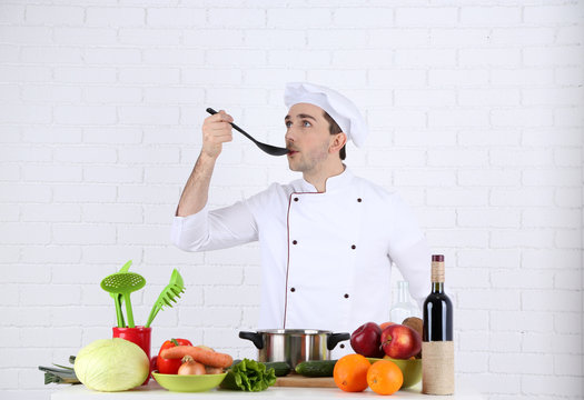 Chef at table with different products and utensil in kitchen